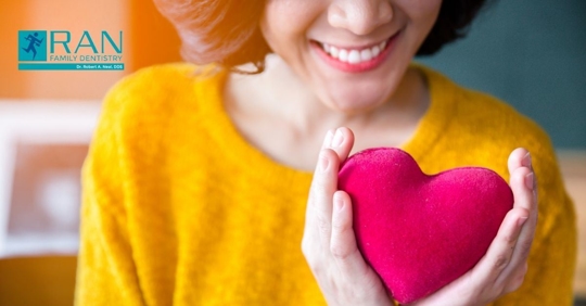 woman holding up heart